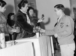 An American serviceman receiving gifts from Chinese civilian representatives in the CBI during WWII.