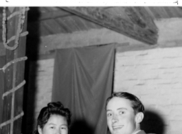 A very young GI enthusiastically talks to a beautiful Chinese woman at a party and dance at the Hostel #10 Officer's Club, Kunming, on January 19, 1945.