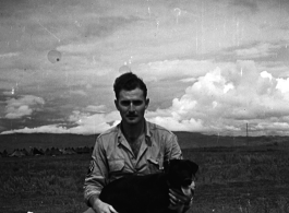 The photographer and collector (name unknown) of this collection, with some large bombs and a dog, most likely around the Luliang air base area. A tent camp is in the far background.