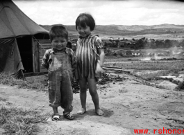 A boy and girl playing in Yunnan, China, near an American air base. During WWII.