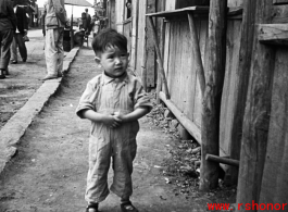 A little boy on the street in Yunnan, China, during WWII.