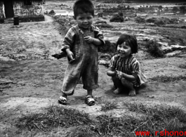 A boy and girl playing in Yunnan, China, near an American air base. During WWII.