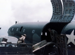 A US C-46 transport plane and cargo in the CBI during WWII.