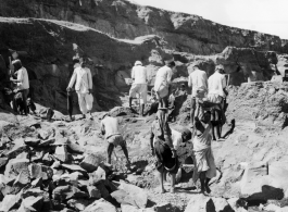 Men quarry rocks by hand.  Scenes in India witnessed by American GIs during WWII. For many Americans of that era, with their limited experience traveling, the everyday sights and sounds overseas were new, intriguing, and photo worthy.