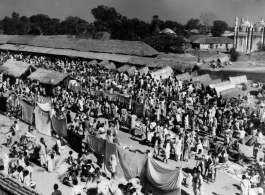 A busy market.  Scenes in India witnessed by American GIs during WWII. For many Americans of that era, with their limited experience traveling, the everyday sights and sounds overseas were new, intriguing, and photo worthy.