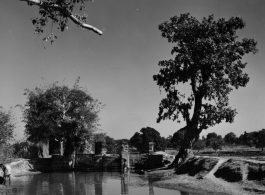 Sluice gates of a water control structure.  Scenes in India witnessed by American GIs during WWII. For many Americans of that era, with their limited experience traveling, the everyday sights and sounds overseas were new, intriguing, and photo worthy.