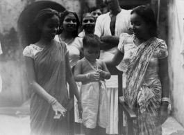 A young boy in India is the pride of his family during WWII.  Scenes in India witnessed by American GIs during WWII. For many Americans of that era, with their limited experience traveling, the everyday sights and sounds overseas were new, intriguing, and photo worthy.