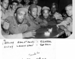 African-American servicemen in a club or bar in Myitkyina in 1945, during WWII. Stars in pre-army life, the fighter Henry Armstrong and the football player Kenny Washington get full attention from surrounding fans.