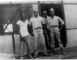 African-American servicemen stand outside the door of an "ORDERLY ROOM" in the CBI during WWII.