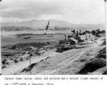 Control tower (arrow, center) and enlisted men's barrack (right center) of the 1339th AAFBU at Chengkung, Yunnan province, China. Four B-24s are scattered around the field.