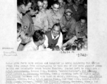 GIs in China enjoy time laughing at movie celebrity Pat O'Brien's jokes.  Seated left to right are S/Sgt. Quisenberry, Pat O'Brien, S/Sgt. Robert L. Sorenson. Standing are S/Sgt. T. W. Wilson, Sgt. Joseph Campion, S/Sgt. Leslie Piehl, S/Sgt. Jerry Dusek, Sgt Wallace Jackson, Sgt. Henry E. Kubieck, Pvt. Gordon Escore. In rear are Pvt. Kenneth Hummel, Sgt. Andrew Adamchik, S/Sgt. Charles J. Kekura, Pvt. Frank Puccio, and Sgt. Stanley Breckner.