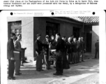 Major General Claire L. Chennault accepts the Victory Banner of the All China Troops Comforting Association from Bishop Paul Yu Pin, as Chinese delegates and members of the staff of the 14th Air Force look on. March 24, 1945