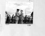 A B-24 bomber crew receives medals for having sunk a 550 foot Japanese cruiser in the South China Sea on August 10, 1944. Here General Chennault pins the Distinguished Flying Cross on 1St. Lst. Lee Cunningham.