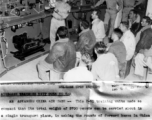 T/Sgt. Murphy D. Shell explains the intricacies of carburetor operation. with a model of P-51 systems set up behind him, to pilots and mechanics. In China.