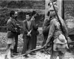 Conscripts being loaded onto transport, or Japanese prisoners being loaded. In China during WWII.