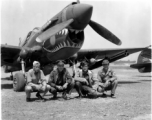 American GIs pose with shark-teeth painted P-40 fighter in the CBI.