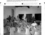 Americans and Chinese enjoy a bit of recreation in "Flanagan's Bar," named for Sgt. Wm. Flanagan, seated third from the left in front row. Lt. Tong, K. T, communications officer for the Chinese Air Force, plays the Chinese violin (二胡).  Image courtesy of Tony Strotman.