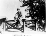 GI enjoying a moment sitting on a rail in Karachi, India, on the way back to the US after the war.