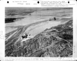 A B-25 bombs 9000-foot Yellow River bridge. June 24, 1944, 1st Bomb Group, Provisional; 2nd Bomb Squadron. Near Kaifeng, Henan, China.