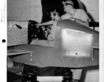 Instrument flying training. Sgt. Kenneth E. Brandon showing Capt. C. C. Wang, Chinese Air force, reactions of setting instruments in link trainer. India.