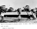 Women carrying baskets on their heads, likely in India. During WWII.  Photo from Robert M. Wilson.