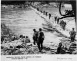 GIs cross Shweli River on bamboo pontoon bridge on January 2, 1945, in the CBI.