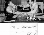 George M. Zdanoff (right) points a finger at Bob Harrington (left) at the photo lab at Hastings Mills, India, HQ during WWII.