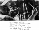 Lt. Robert Meyer in the cockpit of a transport plane (C-46 or C-47 most likely), with sticks on adjustment knobs to act as auto pilot.  332nd Troop Carrier Squadron. In the CBI during WWII.  Photo by W. R. McKenzie.