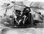 A GI sits in the cockpit of a reconnaissance F-5 (P-38) in the CBI. "Fleming- Lab. Commander."