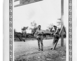 GI Carroll Cummings, 80th Fighter Group, pauses for a moment with a Chinese soldier (pockets full of grenades) on the Stilwell Road/Ledo Road, during WWII.