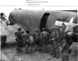 Tired Merrill's Marauders queuing up to board a C-47 transport plane, probably at Myitkyina, Burma. During WWII.