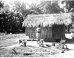 A young girl stands before a hut in India.  Local images provided to Ex-CBI Roundup by "P. Noel" showing local people and scenes around Misamari, India.    In the CBI during WWII.