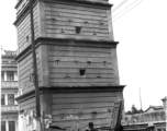 A gun tower fortress in Yunnan province, China, probably in Kunming city, during WWII. Note the desks set up for various kinds of business on the sidewalk in the foreground.