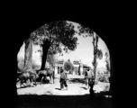 People as seen through a large town gate in Yunnan province, China, during WWII.