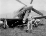 Elmer Bukey poses for a photo in front of a P-51 at Liangshan, China, during WWII.