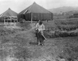 A woman in China holds a freshly skinned piece of vital protein--a cat or dog or similar. During WWII.