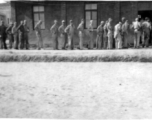 GIs at a base in China line up to go into a building.