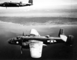 In this intriguing photo, two B-25Cs of the 491st Bomb Squadron fly near the coastline in the CBI. Despite significant damage to the photo itself, still the content is very eye catching, so much that one wonders who the men in the turret and cockpit were.