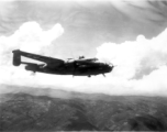 B-25 Mitchell bomber #448 in flight in the CBI, in the area of southern China, Indochina, or Burma.