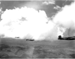 B-25 Mitchell bombers and P-38s in flight in the CBI, in the area of southern China, Indochina, or Burma.