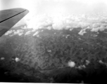 A rough karst mountain landscape as seen from a B-25 Mitchell, in SW China, or Indochina, or the China-Burma border area.  