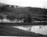 Tent city of flooded living quarters at Liangshan. Stream next to the site has overflowed in this image. During WWII.