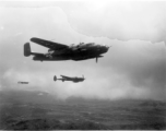 B-25 Mitchell bomber, tail number #448, and P-38s in flight in the CBI, in the area of southern China, Indochina, or Burma.