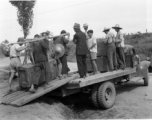 Moving supplies by truck and hard human labor in China during WWII.  From the collection of Hal Geer.