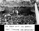 "On troop ship USS Brazil. Skit 'Calling Mr. Galloway.' Jules Kaufman & Johnny Klock of the 16th CCU in the middle of the group."  GIs on the way back home in the US after the war. The viewers include dozens of African-American GIs mixed in, before the stage.