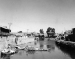 A canal near Kunming, China, during WWII, with boats.  From the collection of Hal Geer.