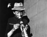 A Chinese man smokes from an elaborate decorated pipe in China during WWII.