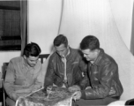 American flyers look over aerial image in the CBI during WWII.