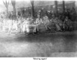 "Moving again."  GIs in transit through a train station in China during WWII. Notice the carbine in one GI's hands.