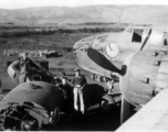 Early in the morning on a spring day in 1945, 491st Bombardment Squadron personnel (mechanics- Schumaier, Scott; armorer- ?) prepare a B-25D, #42, for a mission. The top of the fuel truck is in the foreground of the revetment at Yangkai AB. When the aircraft were dispatched to 'forward operation' bases they were often fueled with hand pumps from 50-gallon drums. Francis Strotman, flight engineer, told of using five-gallon 'jerry cans' to transfer fuel from a C-46 transport to his B-25 in order to have enoug